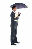 Businessman holding a file under umbrella