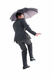 Businesswoman in suit holding umbrella