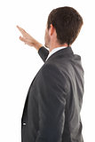 Focused businessman standing and pointing