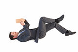 Businessman lying on the floor reading a book