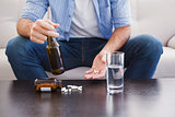 Close up of man showing pills and holding bottle