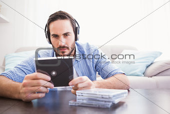 Man holding cd while listening to music