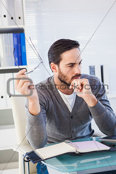 Young businessman organizing his schedule at his desk