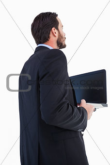 Businessman in suit holding laptop