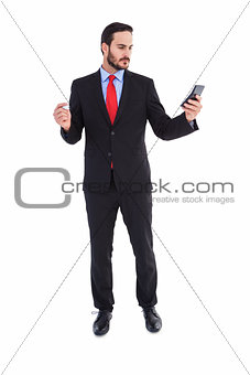 Handsome businessman texting on phone
