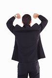 Rear view of businessman standing with arms raised