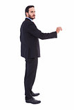 Serious businessman standing with arms raised