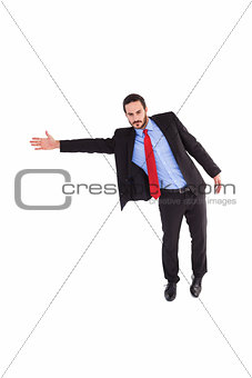 Serious businessman in suit gesturing with hand