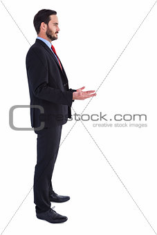 Frowning businessman presenting with hands
