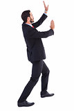 Businessman standing and pushing up