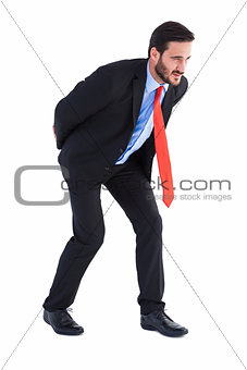 Businessman in suit carrying something heavy