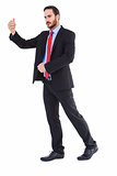 Serious businessman standing with arms raised