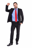 Unsmiling businessman standing with hand raised