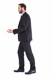 Businessman walking and presenting with hands