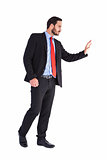 Businessman walking and presenting with hands