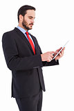 Businessman scrolling on his digital tablet