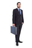 Focused businessman holding a briefcase