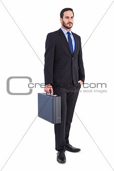 Focused businessman holding a briefcase