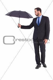 Businesswoman in suit holding umbrella