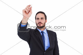 Businessman holding a chalk and writing something