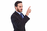 Focused businessman pointing in suit jacket
