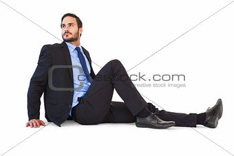 Relaxed businessman sitting on the floor