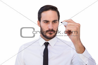 Focused businessman writing with marker