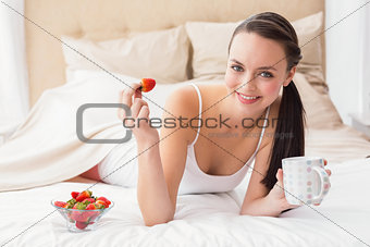 Pretty brunette having breakfast in bed