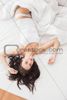 Pretty brunette posing in bed