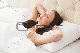 Pretty brunette lying in bed