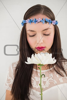 Pretty hippie smelling a flower