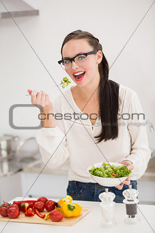 Pretty brunette preparing a healthy salad
