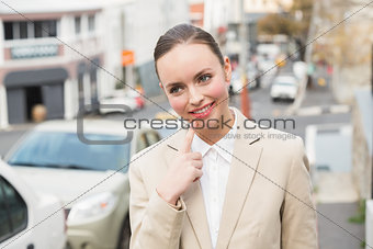 Young businesswoman smiling and thinking