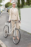 Young businesswoman standing with bike