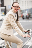 Young businesswoman riding her bike