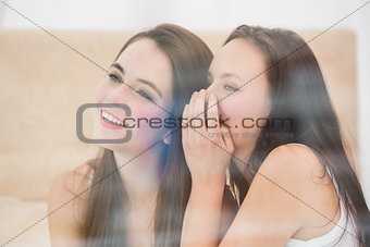 Pretty friend telling a secret