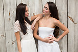 Pretty friends posing in white dresses