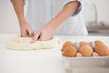 Woman kneading dough on counter
