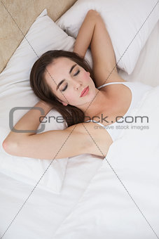 Pretty brunette lying in bed sleeping