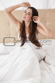 Pretty brunette waking up in bed