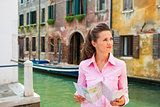 Young woman with map in venice, italy