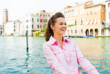 Portrait of happy young woman on grand canal in venice, italy