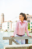 Portrait of happy young woman on grand canal in venice, italy