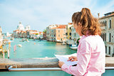 Young woman standing on bridge with grand canal view in venice, 