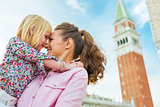 Portrait of mother and baby hugging against campanile di san mar