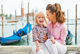 Portrait of happy mother and baby on grand canal embankment in v