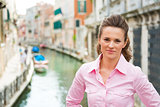 Young woman standing on bridge in venice, italy