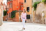 Young woman walking in venice, italy
