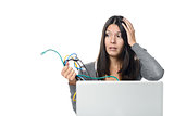 Woman holding Cables in her  hand while Using Laptop