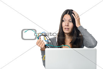 Woman holding Cables in her  hand while Using Laptop